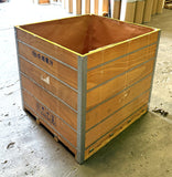 Wooden shipping crate with metal frame on a concrete floor