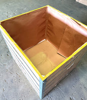 WOODEN CRATE  with yellow rim on a concrete floor